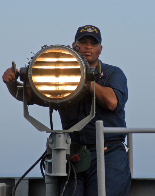U.S. signalman using morse code flash telegraphy in 2005.