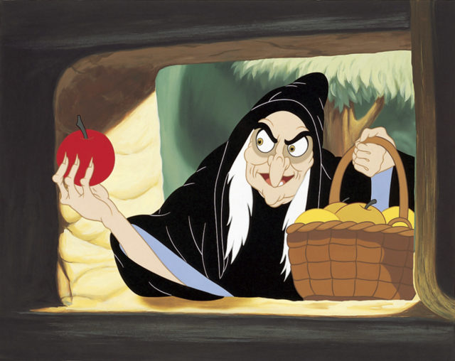 The Wicked Witch holding an apple