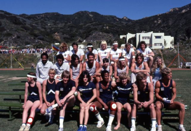 Cast of Battle of the Network Stars sitting on bleachers