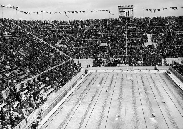 Overhead view of the Berlin Stadium swimming pool with people watching from the stands