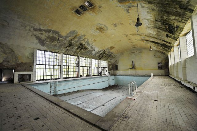Empty swimming pool in a decaying building