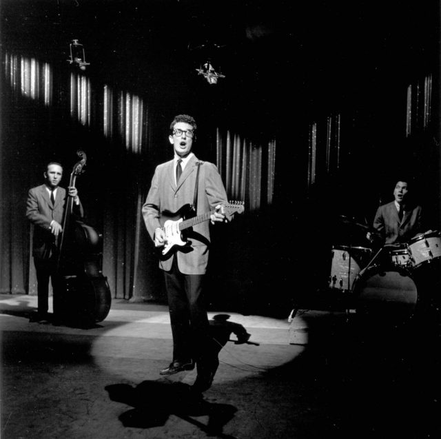 Buddy Holly and the Crickets performing under a spotlight