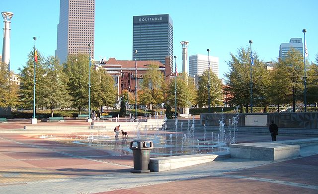 A man and his dog playing in the fountains at Centennial Olympic Park