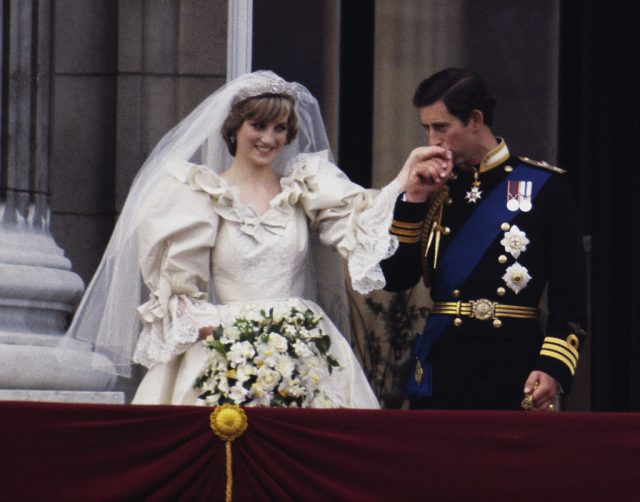 Charles kissing Diana's hand on the balcony of Buckingham Palace