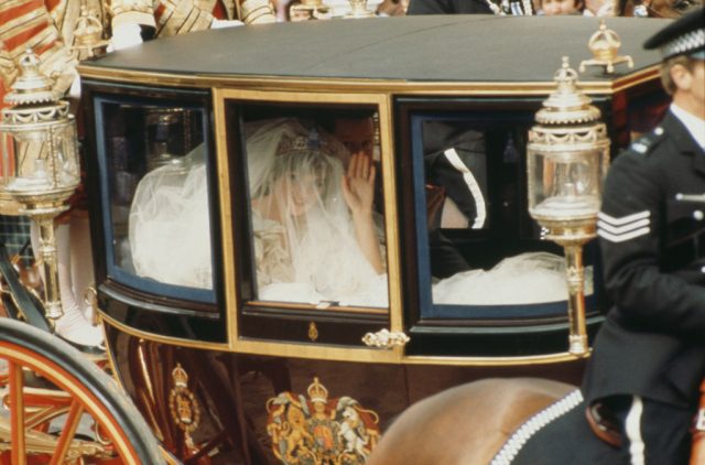 Diana waving out the window of the Glass Carriage with her veil covering her face