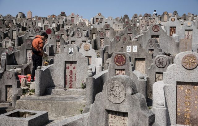 A man pays his respects at a cemetery ahead of the Ching Ming Festival, or grave-sweeping day, in Hong Kong on April 2, 2017.