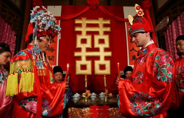  A newlywed couple, the groom from France and bride from China, attend their Chinese style wedding ceremony at the Grand Sight Garden on May 5, 2007 in Beijing, China