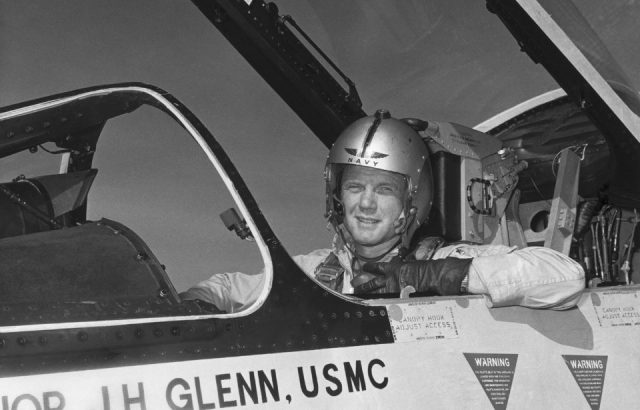Major John Glenn of the USMC poses in the cockpit of an F-8 Fighter.