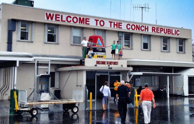 "Welcome to the conch republic" sign at key west airport