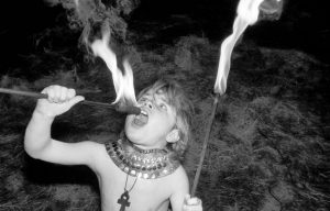 child practicing fire-eating 1950s