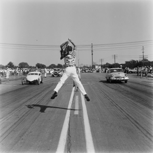 1958 NHRA National Drag Races - Oklahoma City. Antics of enthusiastic flag men add to the excitement at the start of each race.