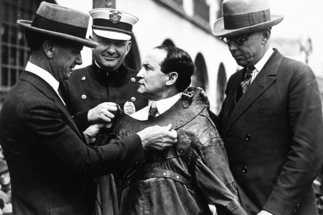 Harry Houdini (1874 - 1926) being fitted into an escape proof suit. 