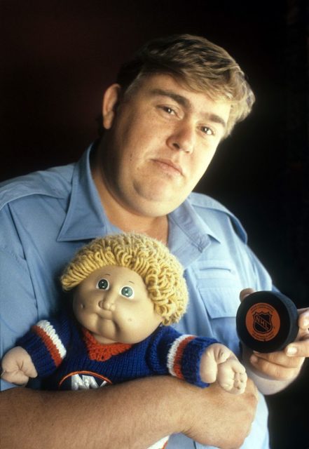 John Candy holding a doll