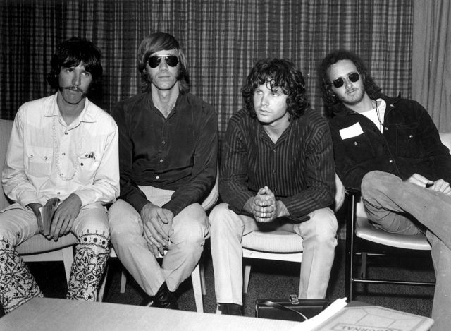 The four members of The Doors sitting in chairs