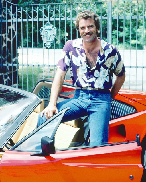 Thomas Magnum sitting in his red Ferrari 308