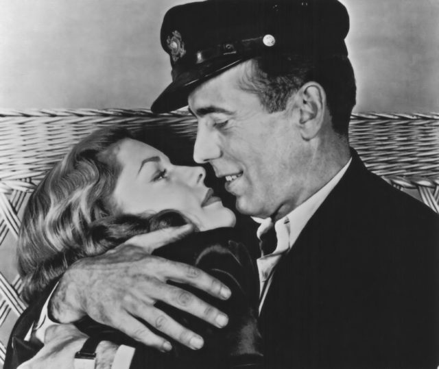 Bogart and Bacall in an embrace on set