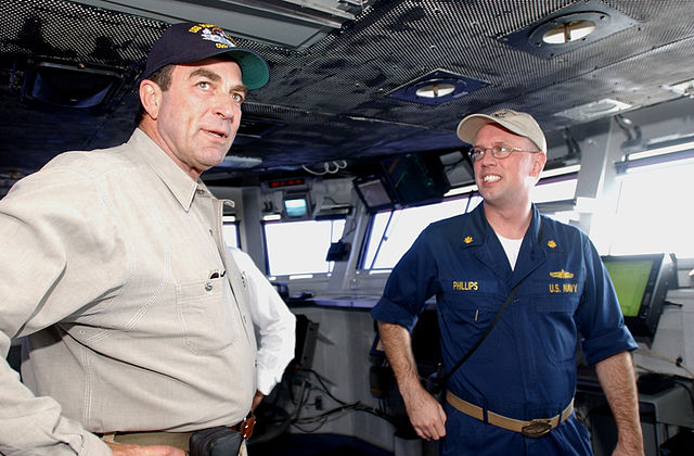 Tom Selleck standing beside Lt. Cmdr Clifton Phillips