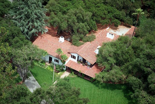Aerial view of a home surrounded by trees
