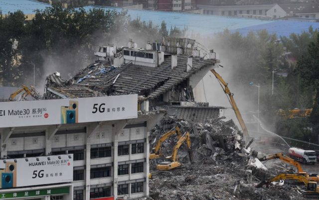 A bulldozer knocking down the stands of the Worker's Stadium