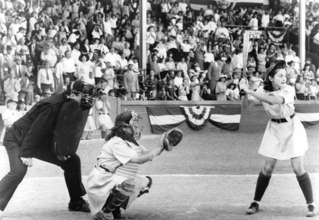 Madonna holding a baseball bat a home plate