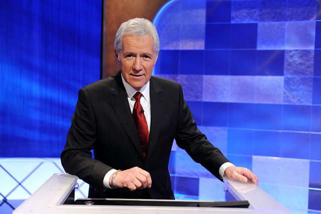 Alex Trebek standing on the 'Jeopardy!' set