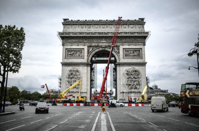 A picture taken on August 4, 2021, in Paris shows the sculptures and the Arc de Triomphe being prepared before the wrapping of the monument.  (Photo Credit: STEPHANE DE SAKUTIN/AFP via Getty Images)