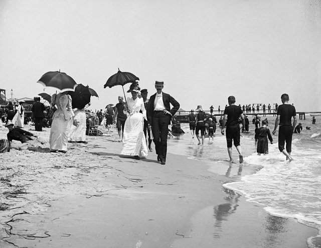 Beachgoers walking along the shore in Atlantic City