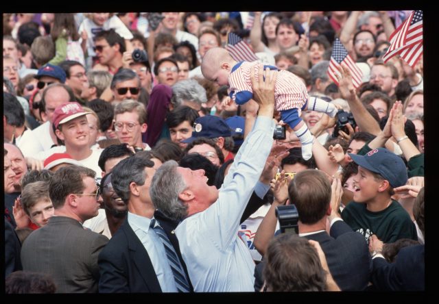 Bill Clinton holding a baby during his 1992 campaign 