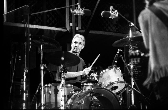Charlie Watts sitting behind a drum kit