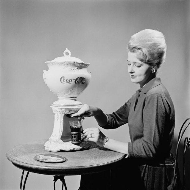 Woman pouring Coca-Cola from a self-serve machine