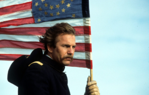 Kevin Costner carrying a flag