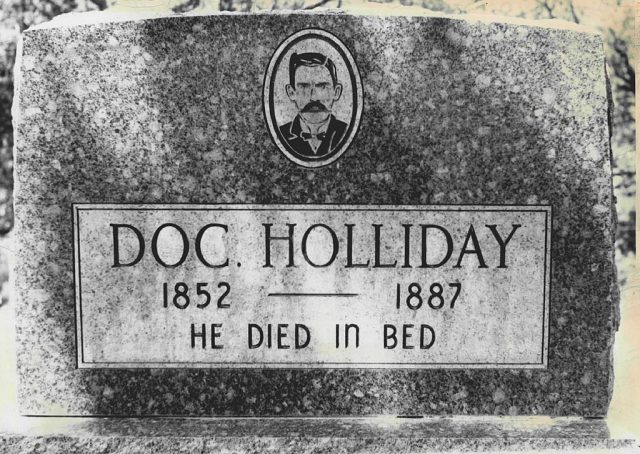Doc Holliday’s Tombstone in Glenwood Springs is Tourist Attraction Today.; He awoke from a coma and took a drink of whiskey. “This is funny,” he said and died.; (Photo Credit: The Denver Post via Getty Images)