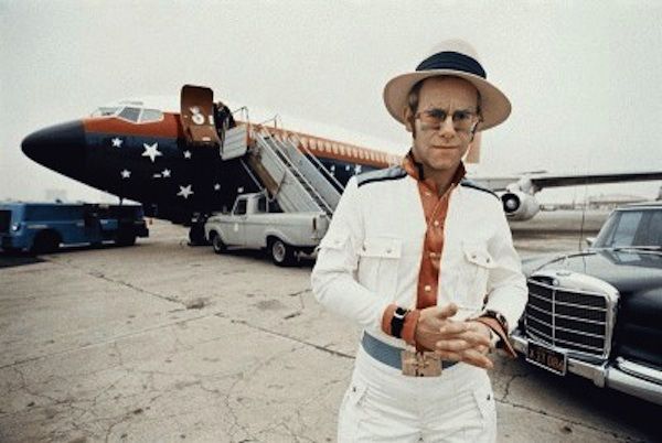 Elton John poses out front of the Starship