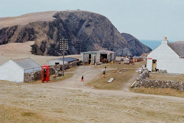 Buildings in front of a hill