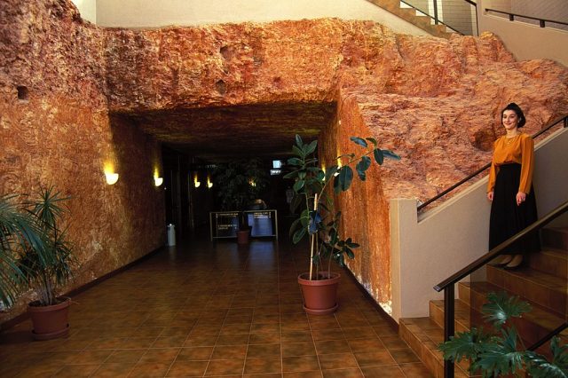 Woman standing on a staircase inside the Desert Cave Hotel
