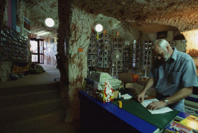 Man working at a store counter