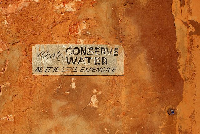 Water conservation sign on a cave wall