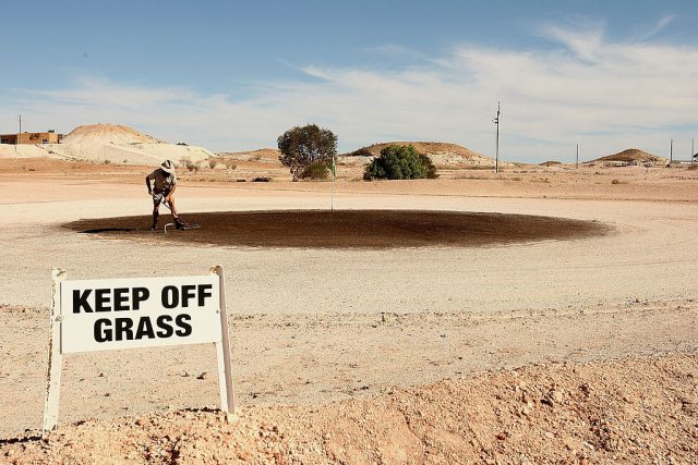 Man raking sand in the desert