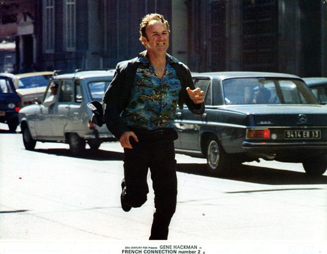 Gene Hackman runs down the street in a scene from the film ‘French Connection II’, 1975. (Photo Credit: 20th Century Fox/Getty Images)