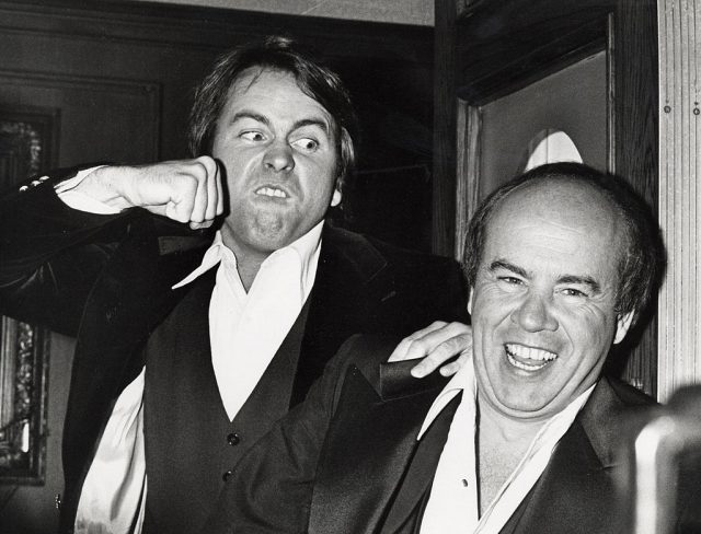 John Ritter holding a fist up to Tim Conway