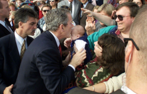 kissing a baby on the campaign trail