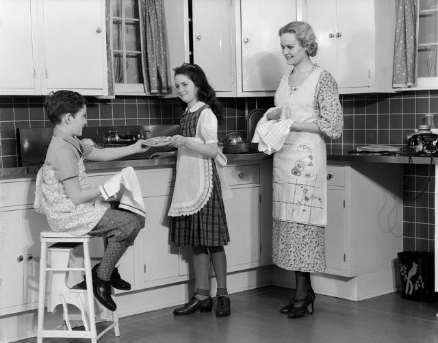 Mother smiling at her children in the kitchen