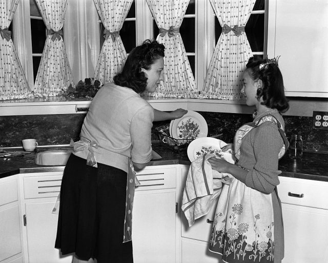 Mother and daughter washing dishes