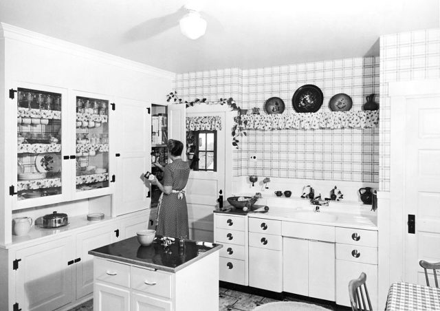 Woman standing in the corner of a kitchen