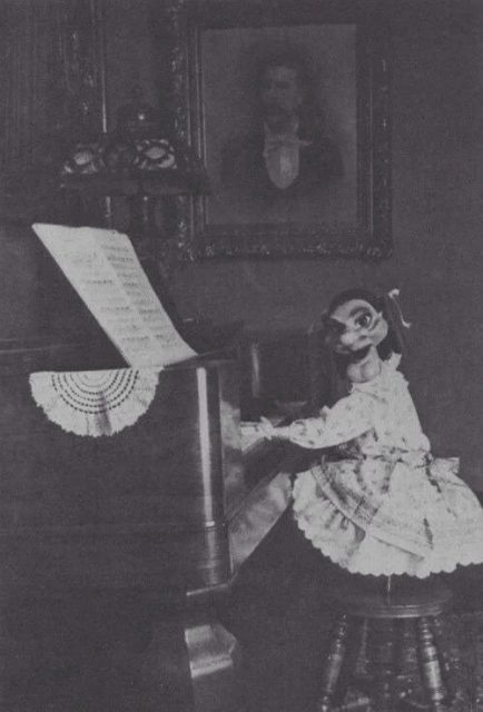 Little girl playing piano in a Madame Mask