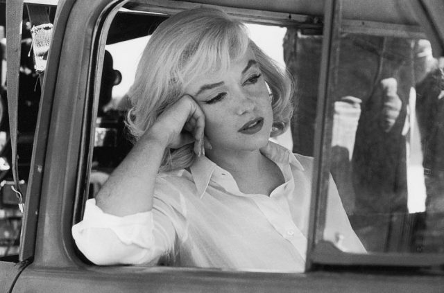 Marilyn Monroe leans out of the open window frame of a car, 1960. (Photo Credit: Ernst Haas/Getty Images)