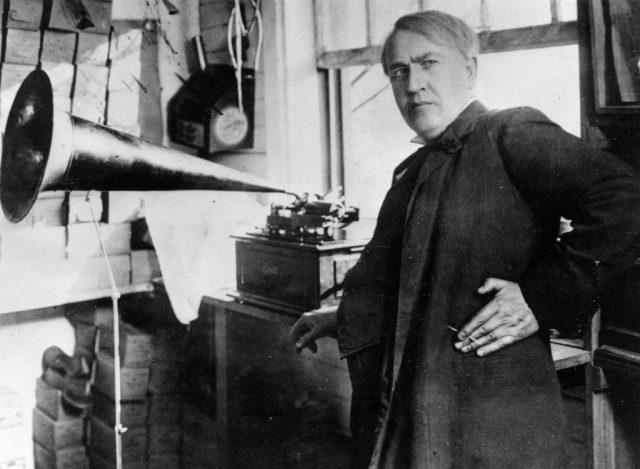 American inventor and businessman Thomas Edison (1847 – 1931) with an Edison Standard Phonograph, at his lab in West Orange, New Jersey, 1906. (Photo Credit: Hulton Archive/Getty Images)