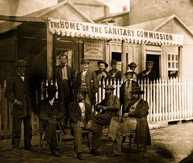 12 men standing in front of the U.S. Sanitary Commission