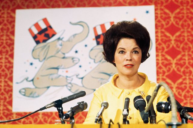 Shirley Temple speaking in front of microphones with a Republican Party poster behind her