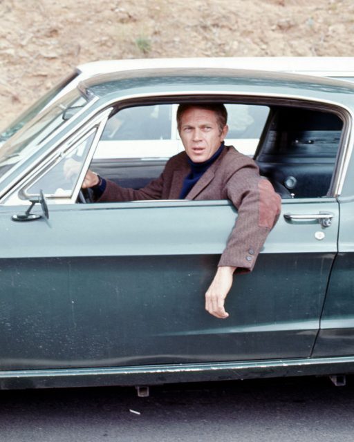 American actor Steve McQueen hangs his arm out the driverside window of a car in a scene from ‘Bullitt’ (directed by Peter Yates), California, 1968. (Photo Credit: Silver Screen Collection/Getty Images)